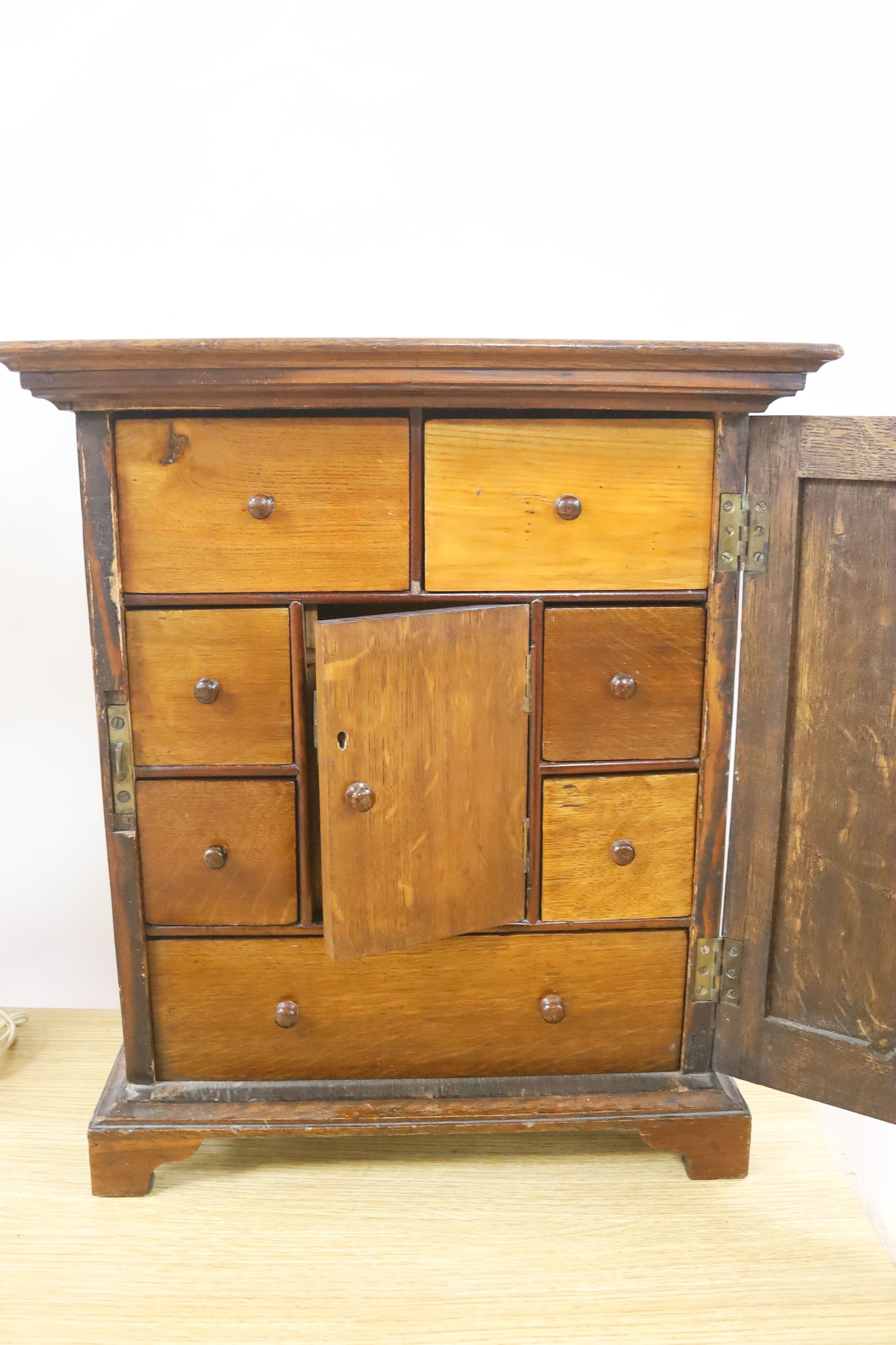 An 18th century and later walnut and oak cabinet of drawers 52cm